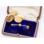 A pair of 15ct gold oval cufflinks, with chain links, one af, scroll decoration, in leather case,