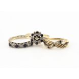 A 9ct gold sapphire and diamond cluster ring, a 9ct gold sapphire and diamond crossover ring and a