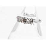 An 18ct white gold three stone diamond ring, the brilliant cuts in claw settings all in white metal,