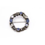 An Arts and Crafts silver moonstone and chalcedony wreath brooch, of circular form, attributed to