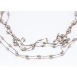 A collection of four matched silver and silver gilt necklaces, of similar design, with oval satin