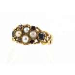 A yellow metal antique emerald, ruby and seed pearl posy ring, with pierced shoulders, engraved