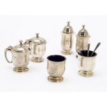 A late 1950s silver cruet set by Adie Bros, comprising a pair of salts, peppers and mustards, with