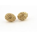 A pair of continental yellow metal clip earrings, of oval bombe shape with stylised engraved leaf