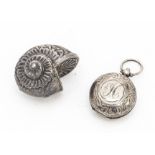Two silver collectables, including a sovereign case and an ammonite shell shaped small case (2)