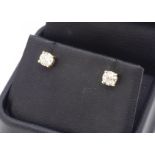 A pair of stud diamond earrings, in yellow metal claw mounts, posts marked 750, diamond weight 1.