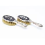 A pair of Edwardian silver and tortoiseshell hair brushes