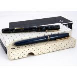 Two vintage fountain pens, a Parker Slimfold and a Swan example, with three Parker boxes