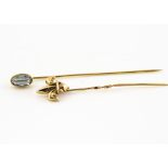 An 18ct gold aquamarine stick pin, the oval mixed cut in collet setting, 1.6g together with a 9ct
