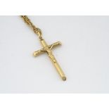 An 18ct gold crucifix pendant, on a 9ct gold double oval linked chain, 27cm together, total