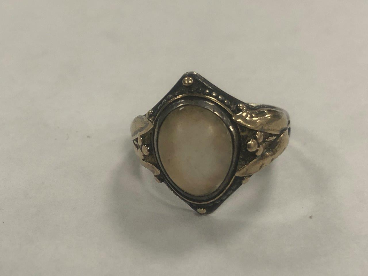 An Arts and Crafts silver and gold moonstone set signet ring, the cabochon oval moonstone within a - Image 5 of 7