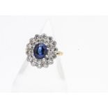 An 18ct yellow and white gold set sapphire and diamond two step cluster ring, with oval claw set