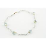 An aquamarine and gold 15ct marked necklace, the faceted circular beads interspersed with gilt metal