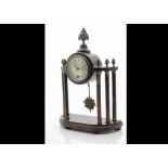 A late 19th Century mantle clock, drum 30 hour movement in wooden surround having vase and flower