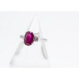 A ruby and diamond step cut ring, the four claw oval mixed cut ruby with baguette cut stepped