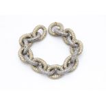 A large oval linked silver and silver gilt paste encrusted chain bracelet, with oval linked clasp of