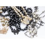Four simulated pearl and base metal opera length necklaces, three with cream coloured pearls, and