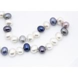 A diamond and cultured pearl necklace, the diamond sphere clasp supporting a knotted strung string