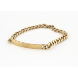 A 9ct gold flattened curb link identity bracelet, the curved unengraved section with chain links