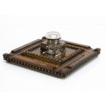 A late Victorian inkstand, the square oak base, 28cm, having a cut glass central inkwell