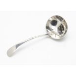 A George V silver straining spoon, 1.4ozt, Old English pattern with grill inset to bowl