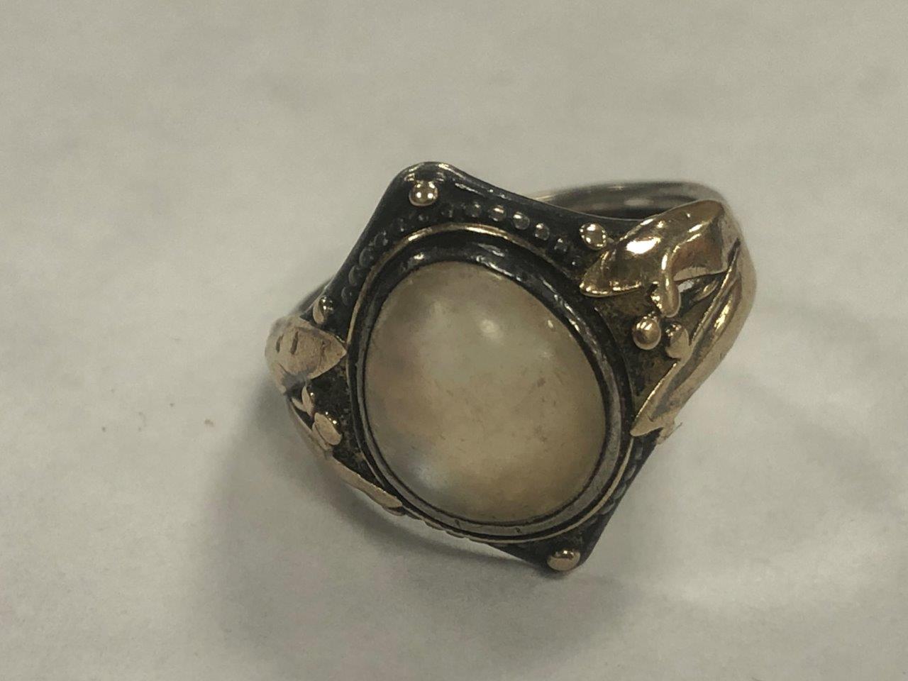 An Arts and Crafts silver and gold moonstone set signet ring, the cabochon oval moonstone within a - Image 4 of 7