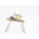 An 18ct gold fancy baguette cut diamond solitaire, and two colour 18ct gold wedding band, diamond