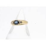 An 18ct gold sapphire and diamond three stone ring, the navette shaped setting with oval mixed cut