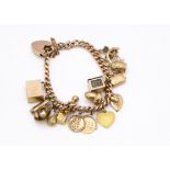 A 9ct gold charm bracelet, with a collection of various 9ct gold charms including a shell and pearl,