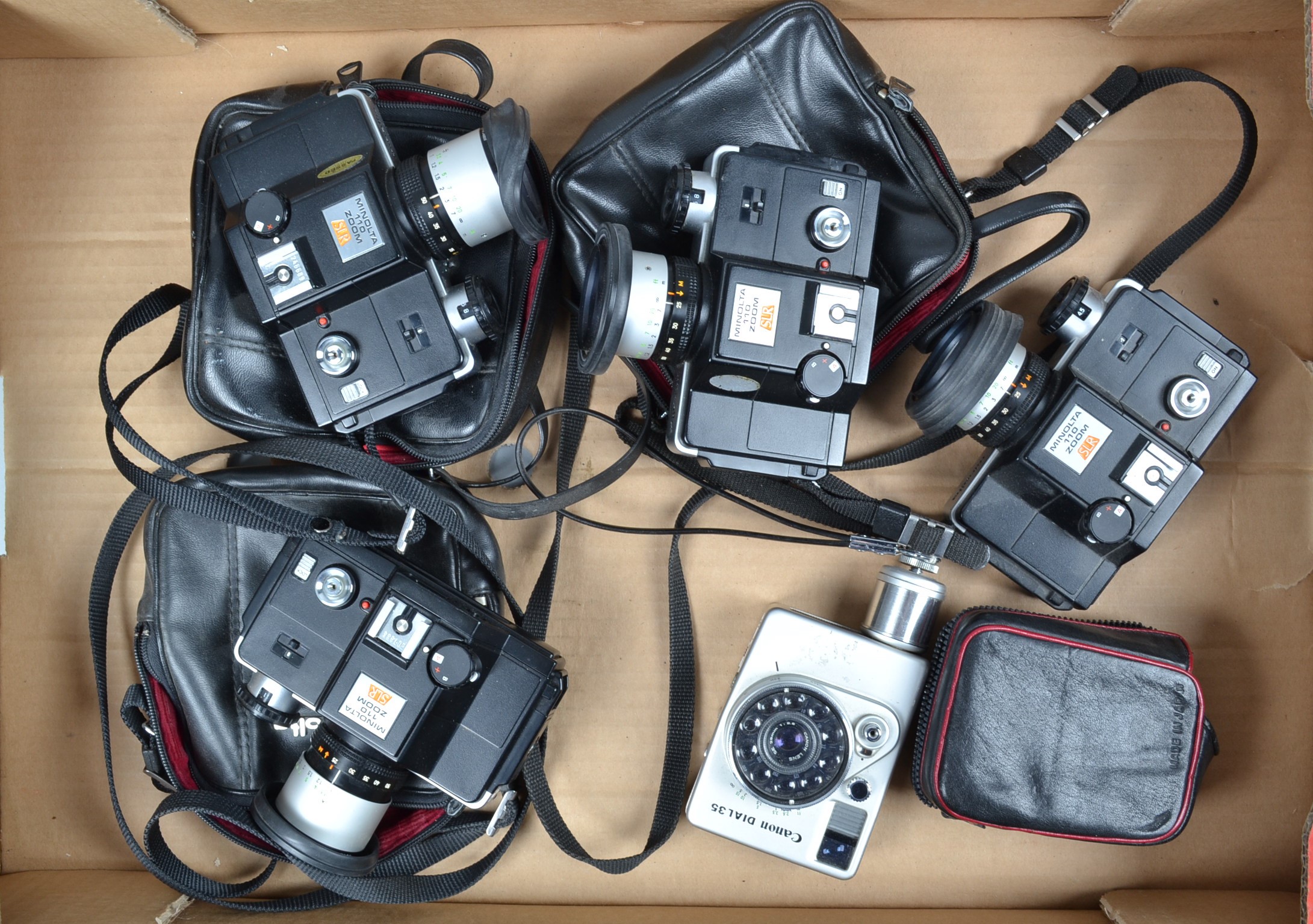 Minolta 110 Zoom SLR Cameras, four Minolta 110 Zoom SLR cameras, three in cases and a Canon Dial