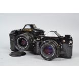 Two Canon SLR Cameras, a Canon A-1, black, shutter not firing, body G, with 50mm f/1.8 FD lens,