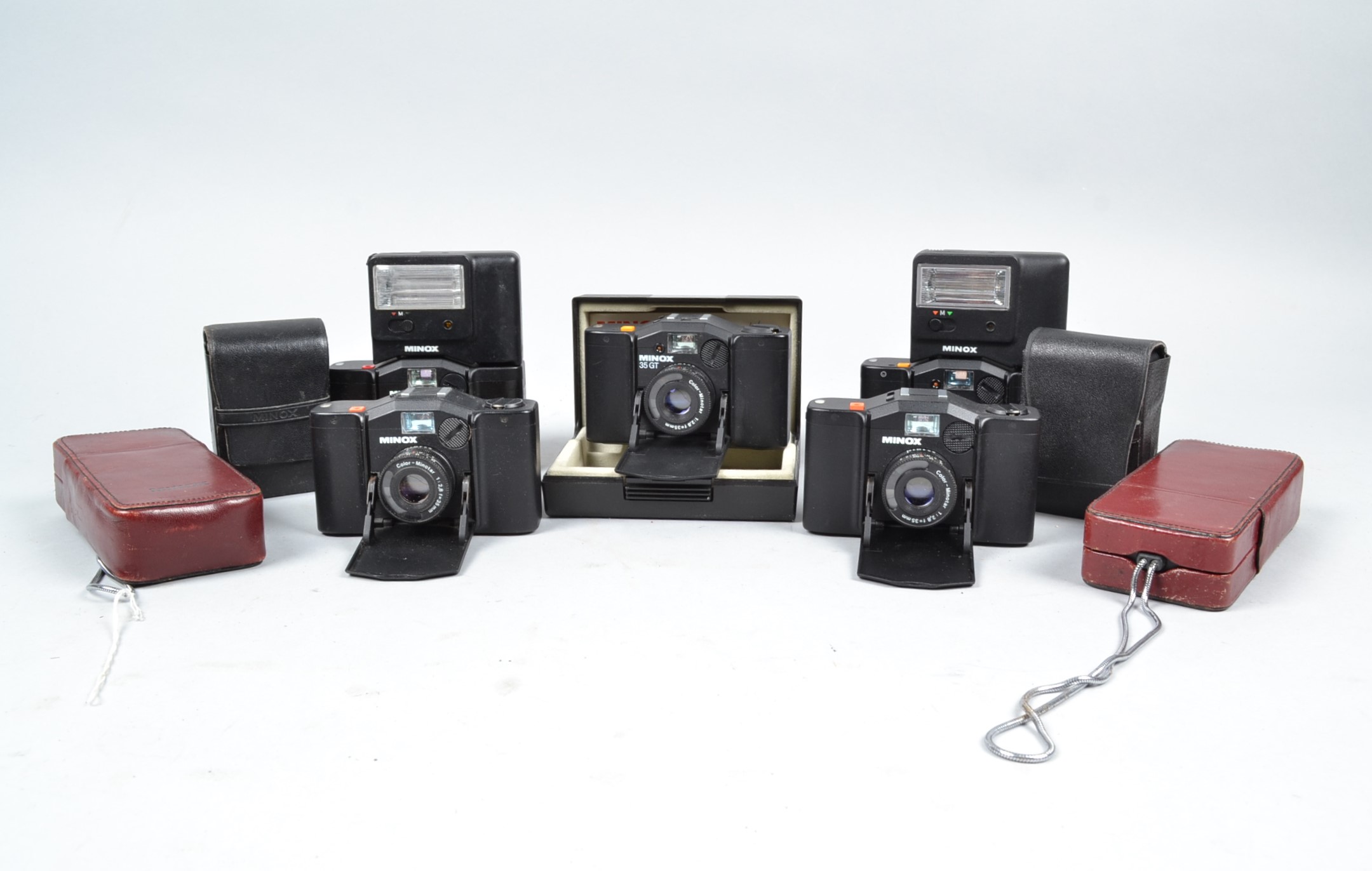 Minox Cameras, two Minox 35 GT, two 35 EL, one 35 GL, two 110 S, in red case, with FC 35 (3) and