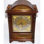 A Victorian oak eight day movement mantle clock, of domed shape, the silvered dial with filigree