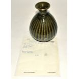 Bernard Leach (1887-1979), a stoneware ovoid stripped bottle vase, all over dark green iron glaze,