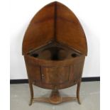 A Georgian mahogany corner washstand, hinged fold down top, platform with cut-outs for bowls,