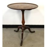 A George III period mahogany occasional tilt top table, moulded edge to circular top on tripod base,
