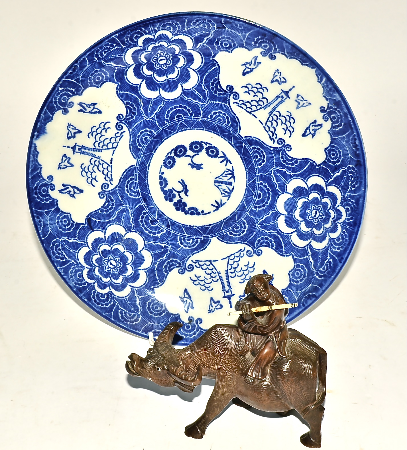 A Chinese boxwood carved water buffalo and rider, 14cm x 15cm, together with a 20th Century Japanese