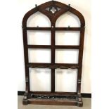A Victorian oak hall stand, Gothic style pierced form with brass coat hooks above umbrella and stick