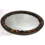 An early 20th Century oval mirror, with floral surround, 51cm x 41cm