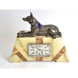 A large Art Deco marble and onyx mantel clock, surmounted with a spelter Alsatian, 38cm high x