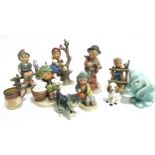 Six Goebel Hummel childhood ceramic figures, boy with rabbits 5870, boy and dog with violin, boy