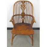 A contemporary oak Windsor arm chair, curved high back with four long spindles either side of a