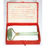 A 20th Century boxed Jade roller, length 12cm