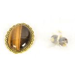 An oval tigers eye brooch, together with two spherical tigers eye earrings (2)