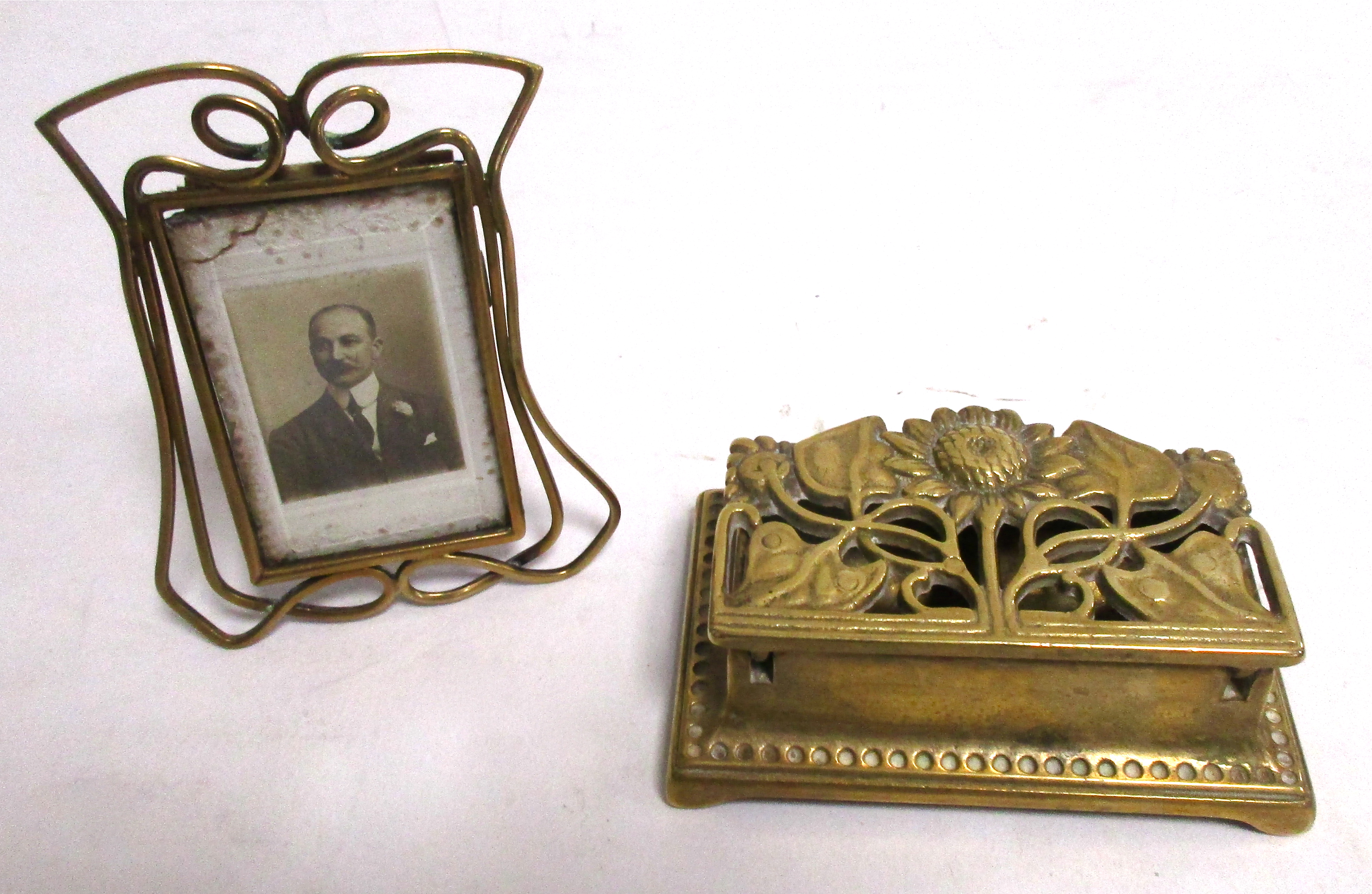 An Art Nouveau brass photograph frame, 9cm x 7cm, together with a cast brass stamp box with