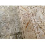 A woollen Zeigler rug, ivory floral field and border, 175cm x 114cm, together with a prayer rug,