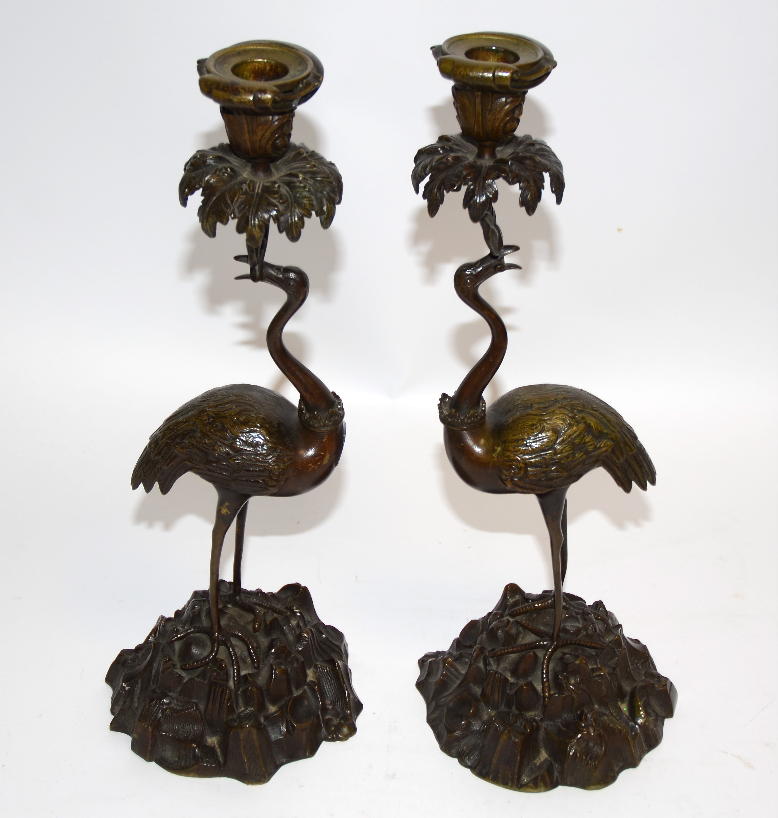 After Thomas Abbott, a pair of bronze figural candlestick holders, taking the form of cranes