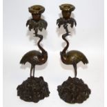 After Thomas Abbott, a pair of bronze figural candlestick holders, taking the form of cranes