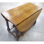 A 1920s oval oak gate leg table, moulded top, raised on barley twist supports, 53cm x 106cm x 74cm
