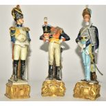 Three Capodimonte porcelain Continental soldiers, raised on square plinth with eagles, height 29.